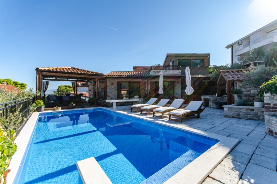 Pool with sun loungers and gazebo