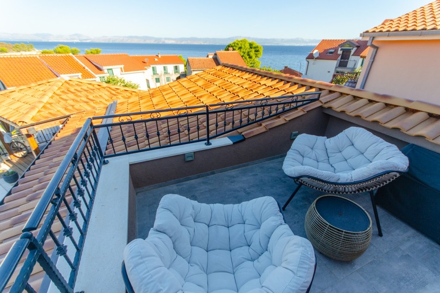 Terrace with armchairs and view of the sea