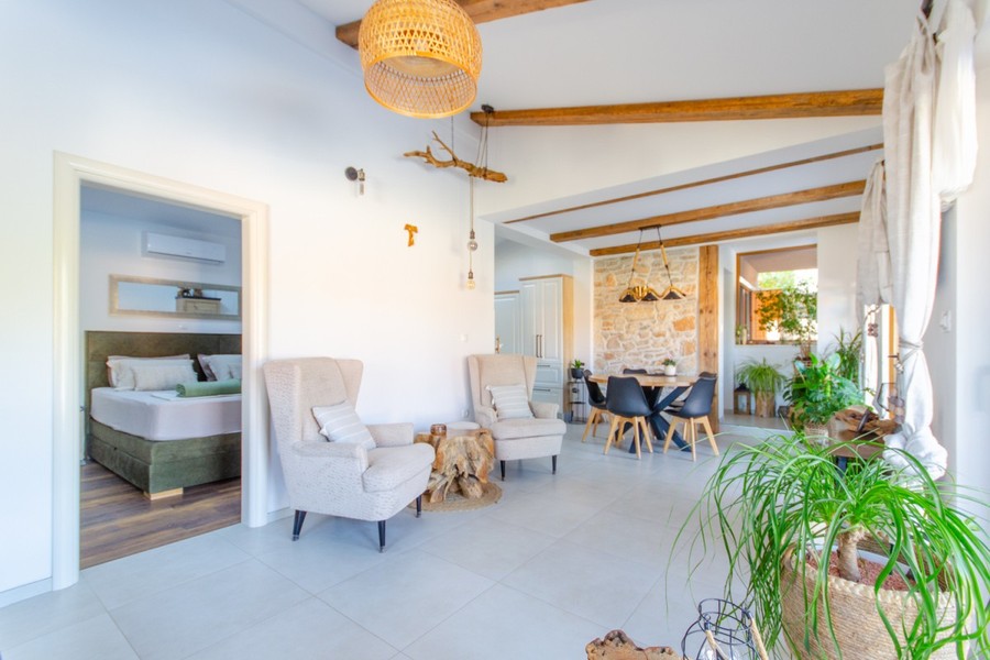Living area with armchairs and view into the bedroom