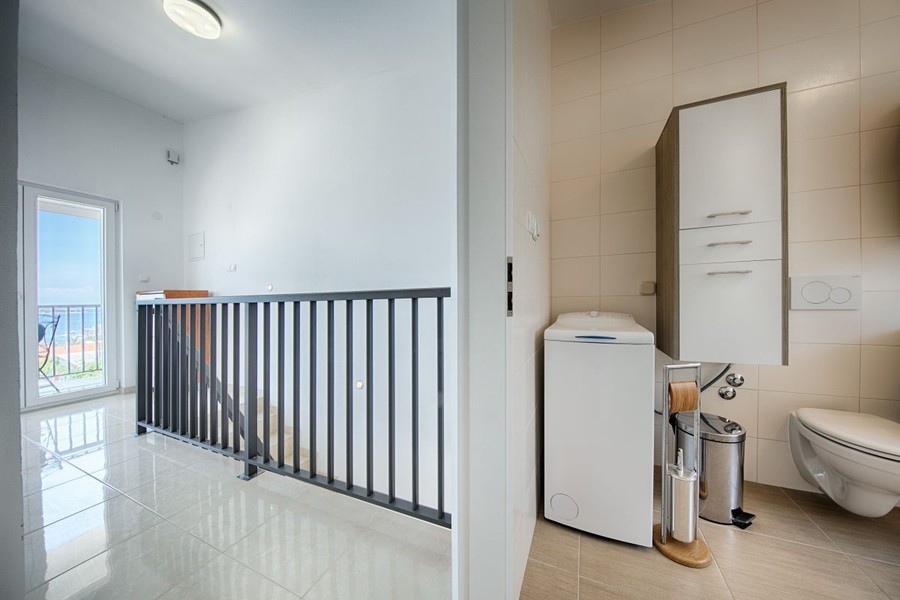 Hallway with staircase and toilet