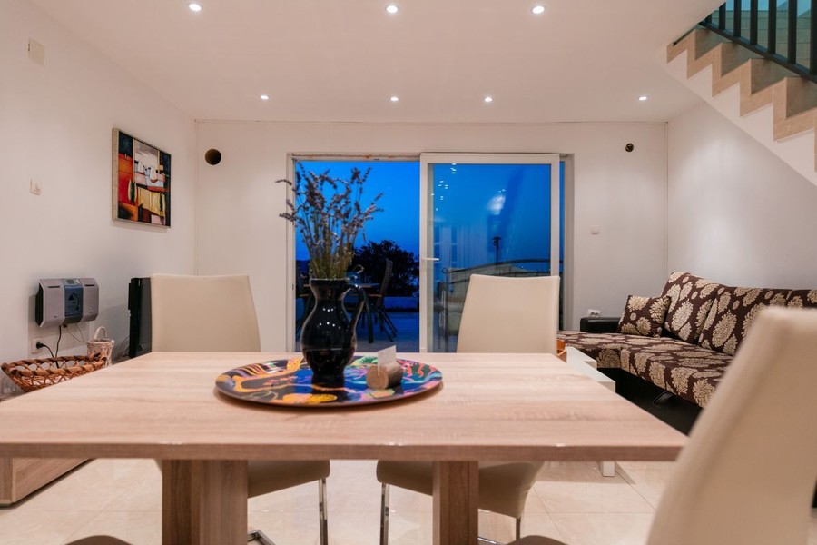 Living room with dining table and glass door