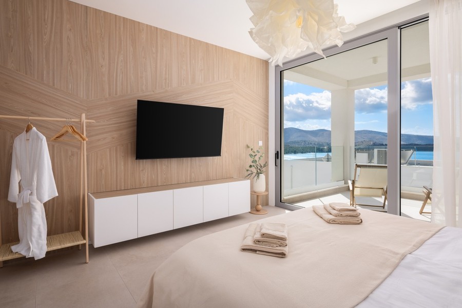 Bedroom with wooden wall and balcony