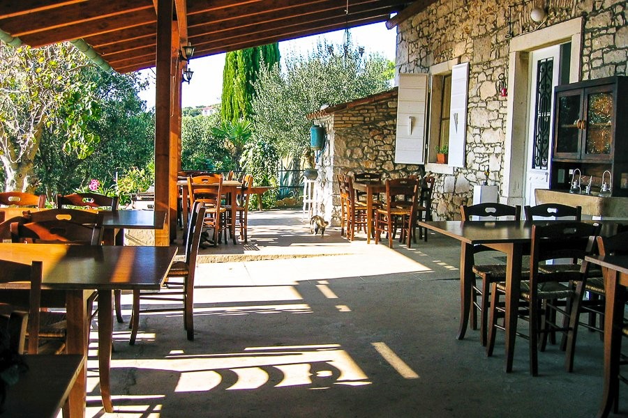 Covered terrace with tables at the stone house