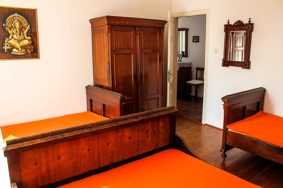 Room with wooden wardrobe and view into the hallway