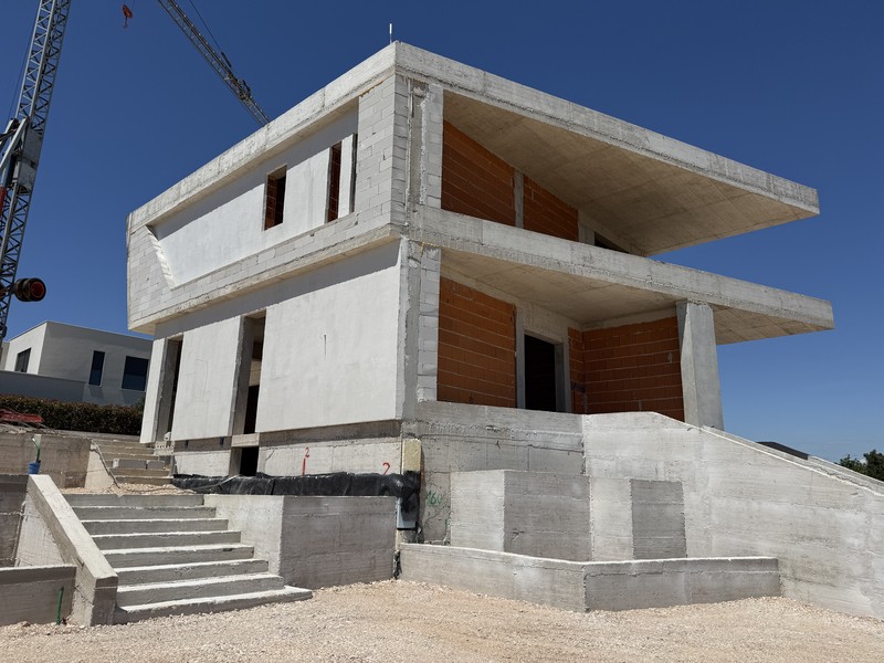 Shell stage of the villa with external staircase, as of June 2026