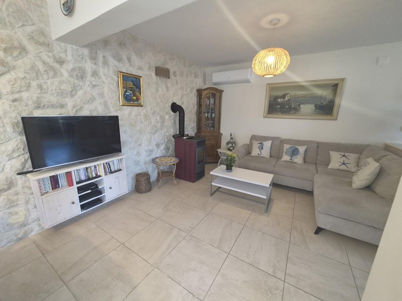 Living room with natural stone wall and pellet stove