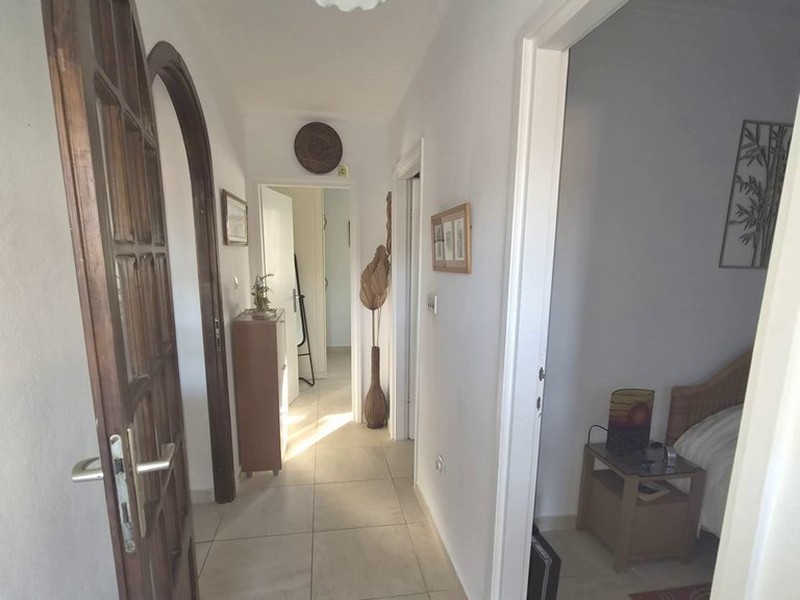 Hallway with wooden door and access to the rooms
