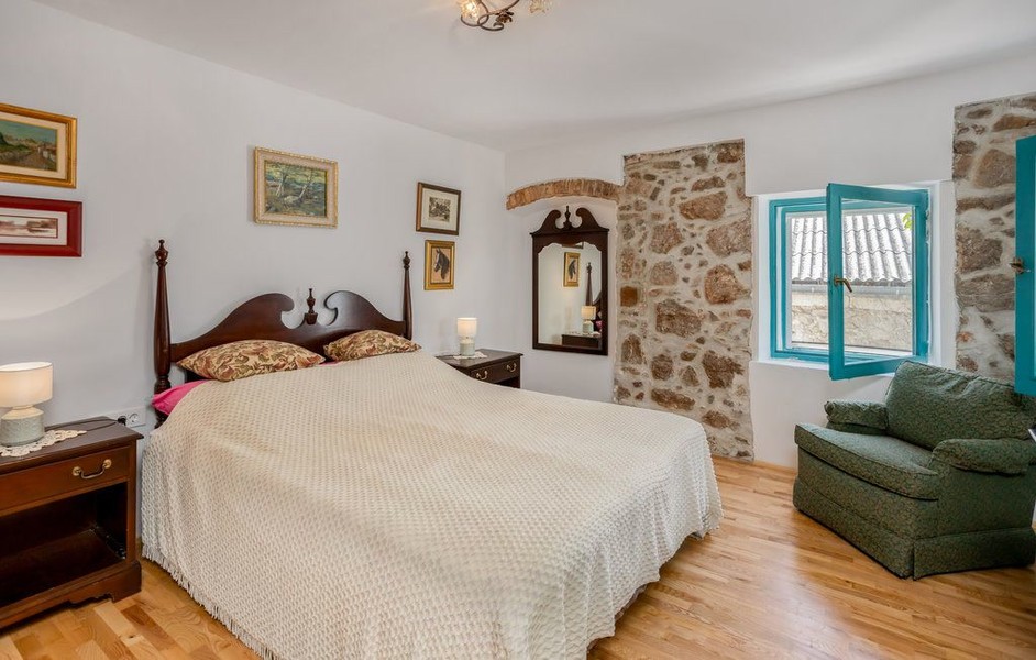 Bedroom with wooden bed and armchair
