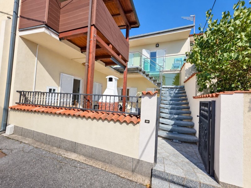 Residential house with external staircase and balcony
