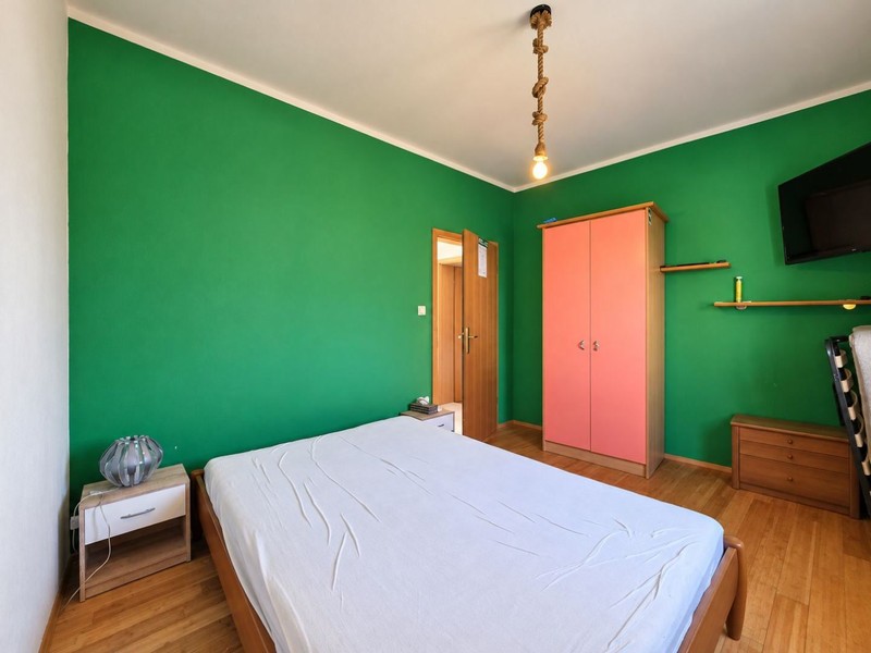Bedroom with green wall and wardrobe