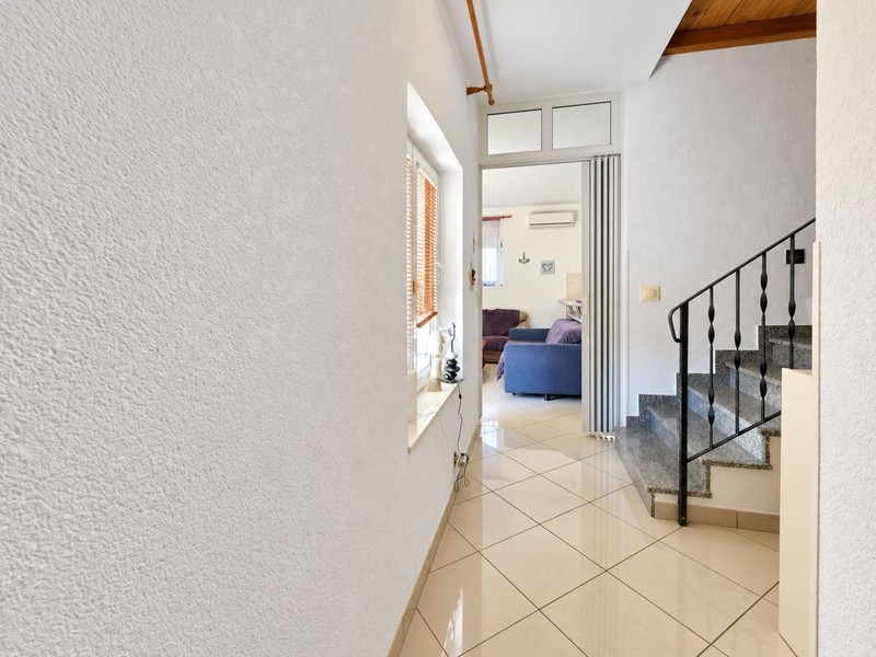 Hallway with staircase and view into the living room
