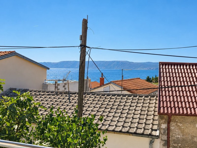 View over the rooftops to the sea and Krk Island