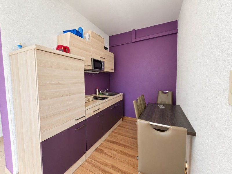 Kitchen with purple cabinets and dining table
