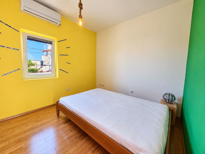 Bedroom with yellow wall and double bed