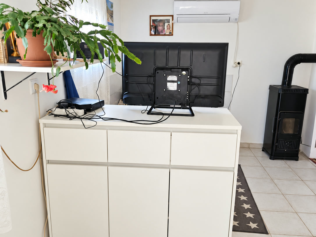 Living area with white cupboard and stove