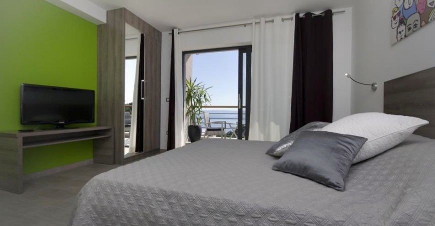Outside there is a swimming pool in a panoramic sea view location.
