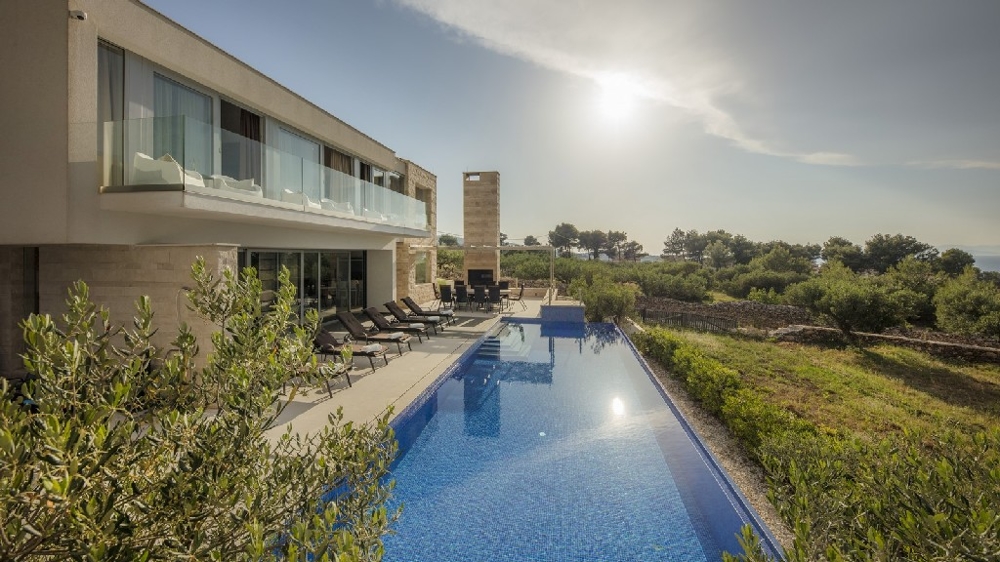 Modern villa with a long pool and loungers on the island of Brac