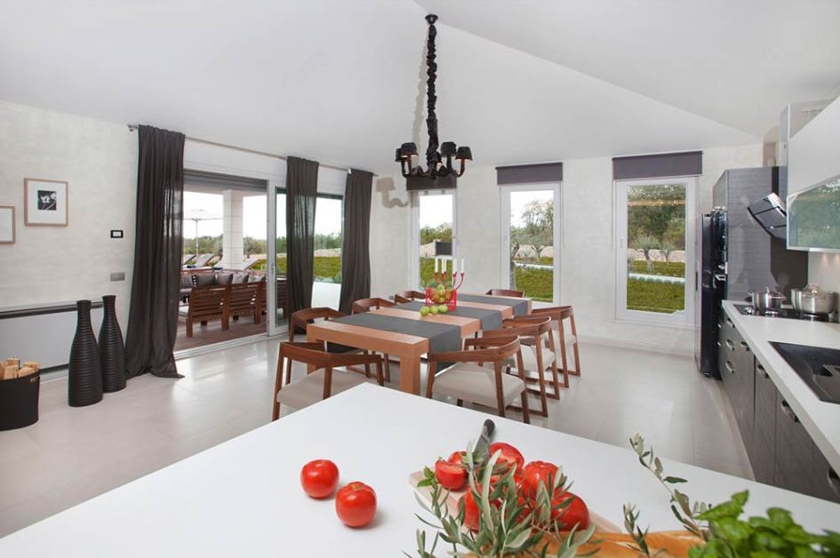 Dining room and one of the several interior kitchens of the villa for sale in Istria.