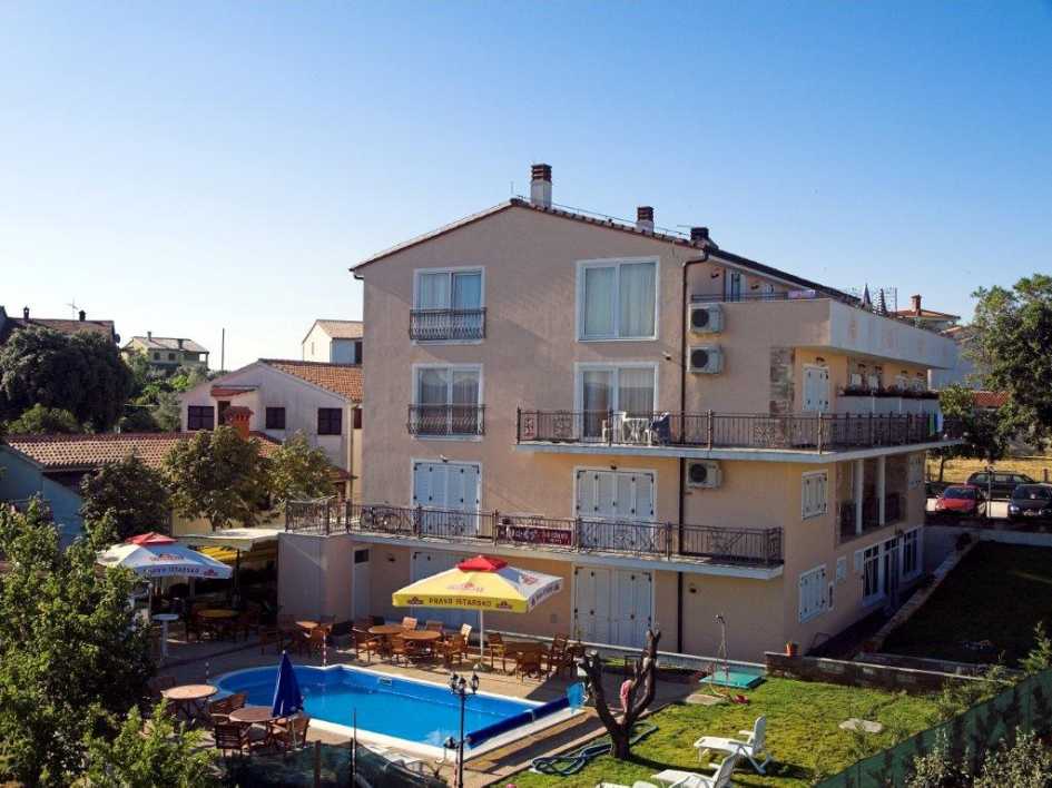 The modern and functionally furnished guesthouse near Pula has sea views and a pool and is for sale
