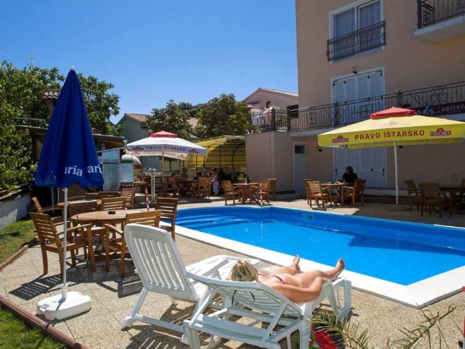The outdoor pool of the guesthouse for sale in Croatia offers space to sunbathe and relax