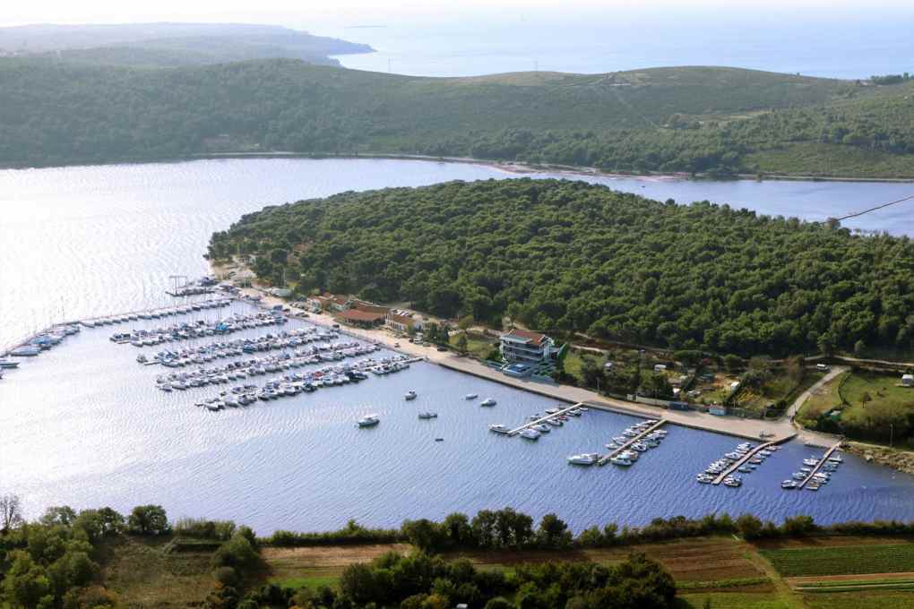 Aerial view of the marina with jetties and wooded peninsula