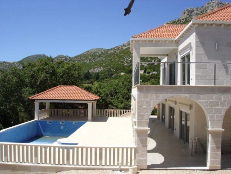 Outdoor area with swimming pool and terraces.