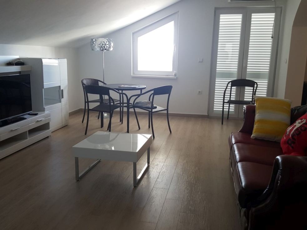 One of the renovated living rooms with kitchen in the apartment villa that is for sale